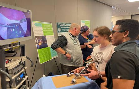 Kai Britton of Hartland, VT, participates in a laparoscopic procedure demonstration using a Lite Brite® toy at 十大博彩推荐排名卫生’s 2023 Career Expo.